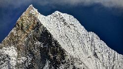 Double-fluted peak of Machepuchare with the steep rock and snow flanks.