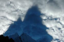 Clouds in the lower parts increase the appearance of the high peaks; the sun creates huge shadows in the morning clouds.