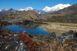 The dark blue lake and the ranges in the background.