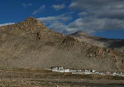The whitewashed houses of Chusar lie below a ruined fort.