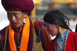 Pilgrim family doing the kora around Jokhang.