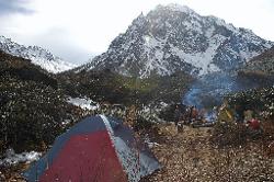 Camp near Chatang on a small clearing between rhododendrons, strange haze announces bad weather.